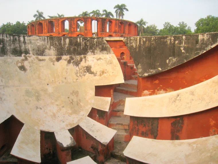 Curving red-and-white masonry astronomical instruments at the Jantar Mantar observatory in Delhi