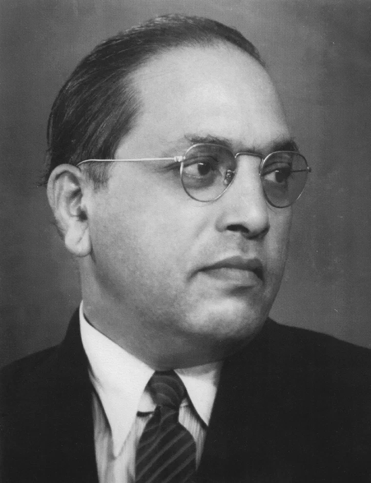Black-and-white portrait of B. R. Ambedkar wearing glasses, a suit, and a tie